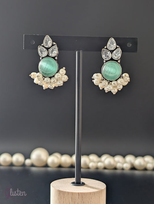 Oxidized German silver earrings with Monalisa stones, American Diamonds (AD), and pearl drops, perfect for traditional wear and special occasions.
