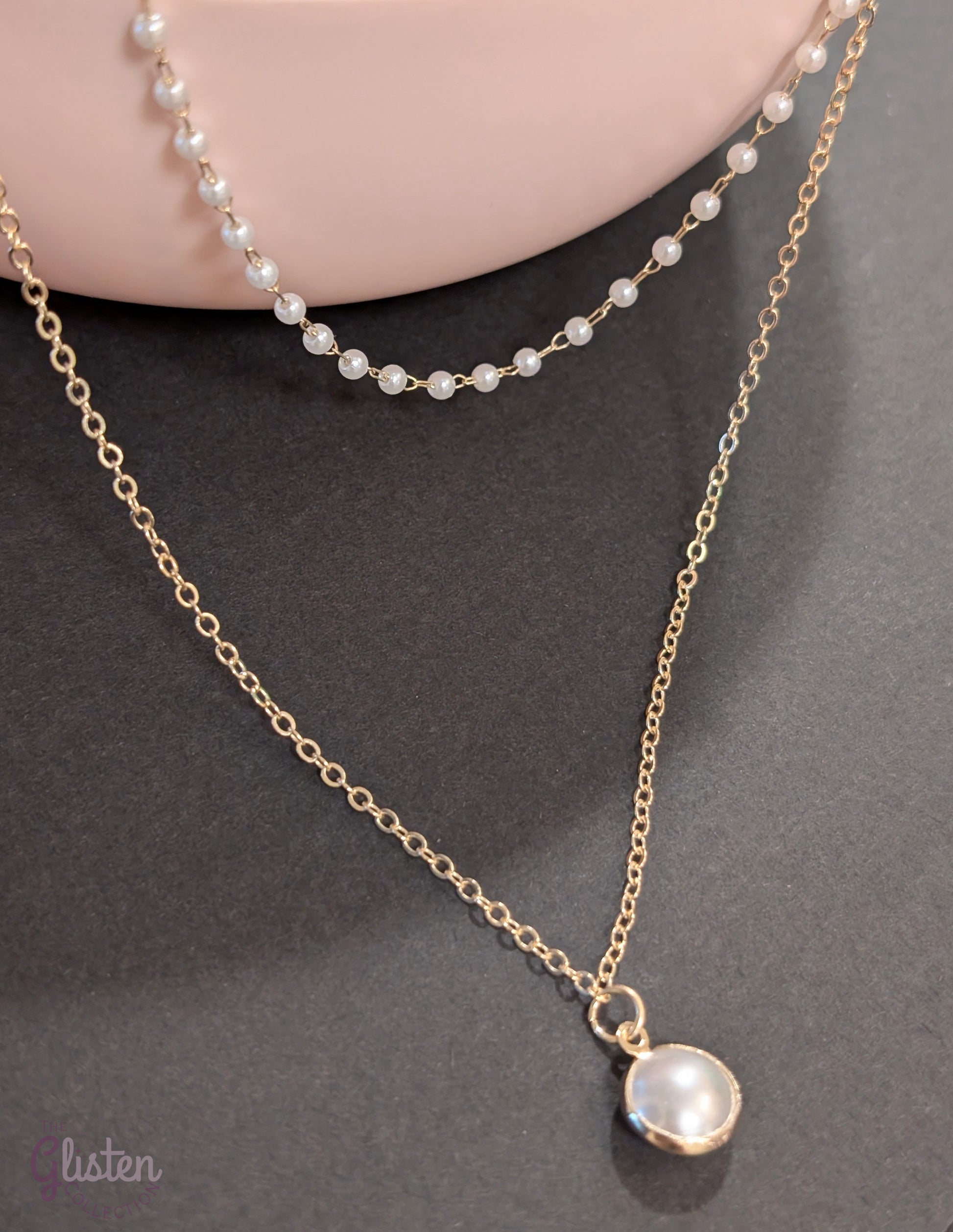 Layered silver chain necklace with pearl accents and a plain strand, ideal for everyday and office wear.