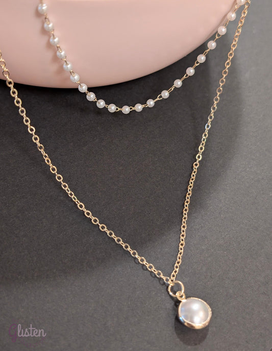 Layered silver chain necklace with pearl accents and a plain strand, ideal for everyday and office wear.