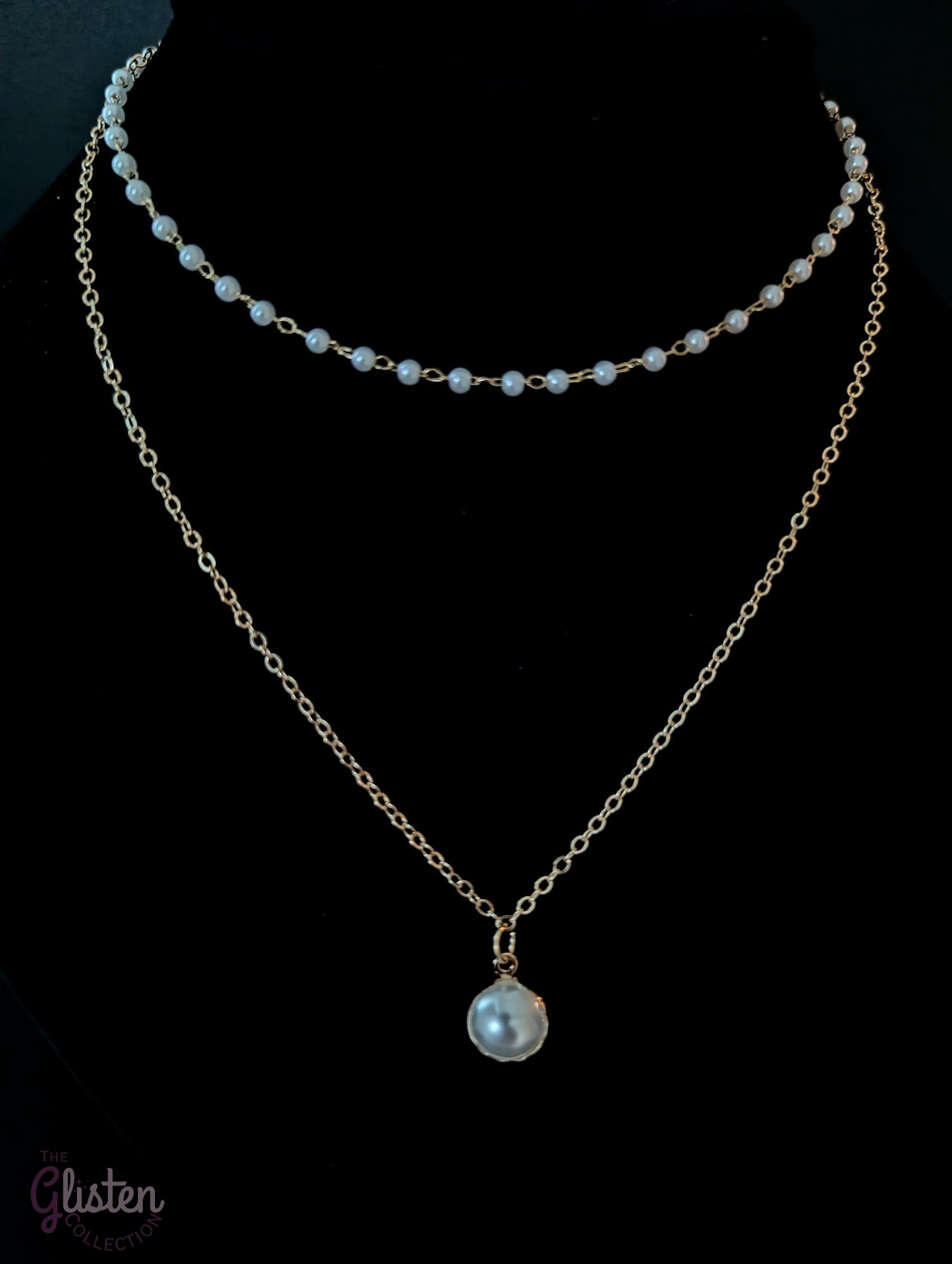 Layered silver chain necklace with pearl accents and a plain strand, ideal for everyday and office wear.