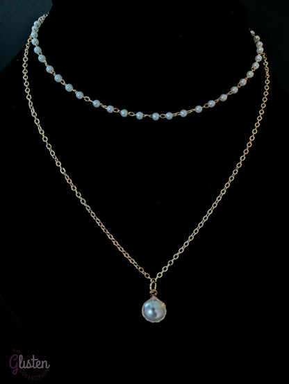 Layered silver chain necklace with pearl accents and a plain strand, ideal for everyday and office wear.