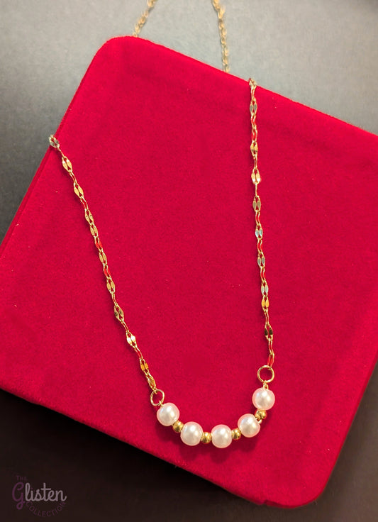 Sleek 18K gold-plated necklace featuring five solid pearl balls as a pendant, offering a refined and minimalist style suitable for everyday elegance.