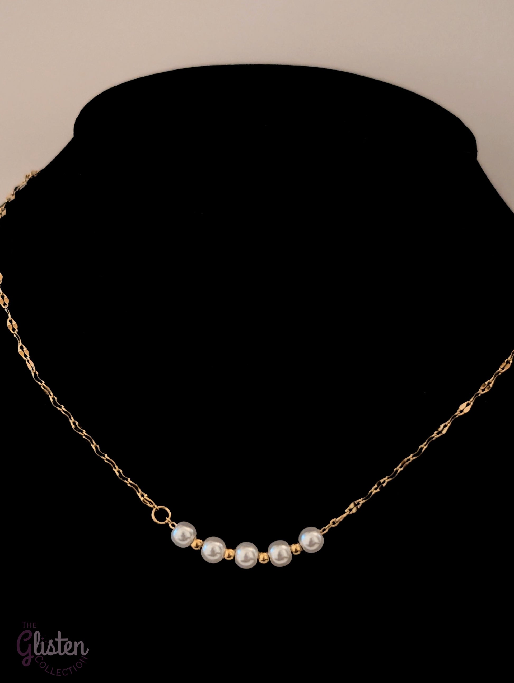 Sleek 18K gold-plated necklace featuring five solid pearl balls as a pendant, offering a refined and minimalist style suitable for everyday elegance.