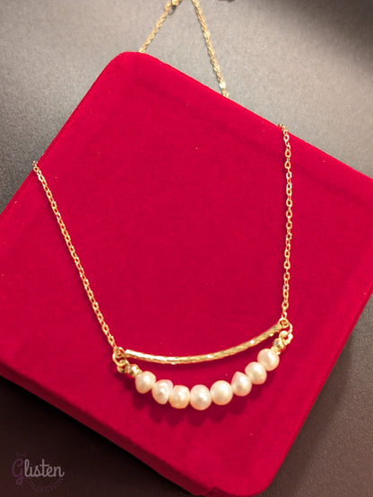 Gold-plated necklace with geometric ring and irregular freshwater pearl drop, a trendy fashion piece with organic elegance.