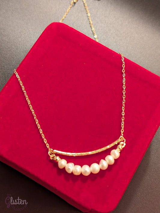 Gold-plated necklace with geometric ring and irregular freshwater pearl drop, a trendy fashion piece with organic elegance.