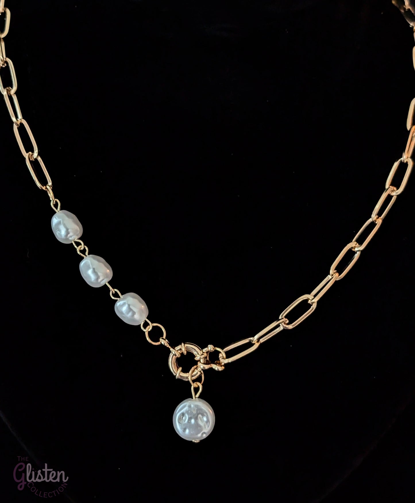 Minimalist round imitation pearl pendant necklace with unique bottom-opening mechanism.