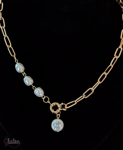 Minimalist round imitation pearl pendant necklace with unique bottom-opening mechanism.