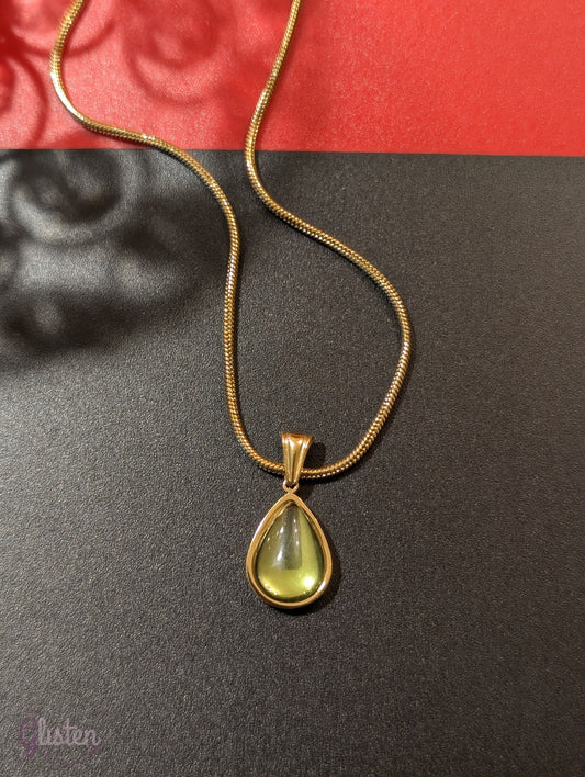 Elegant green glass droplet pendant necklace with stainless steel and 18K gold plating, offering a minimalist and refined look.