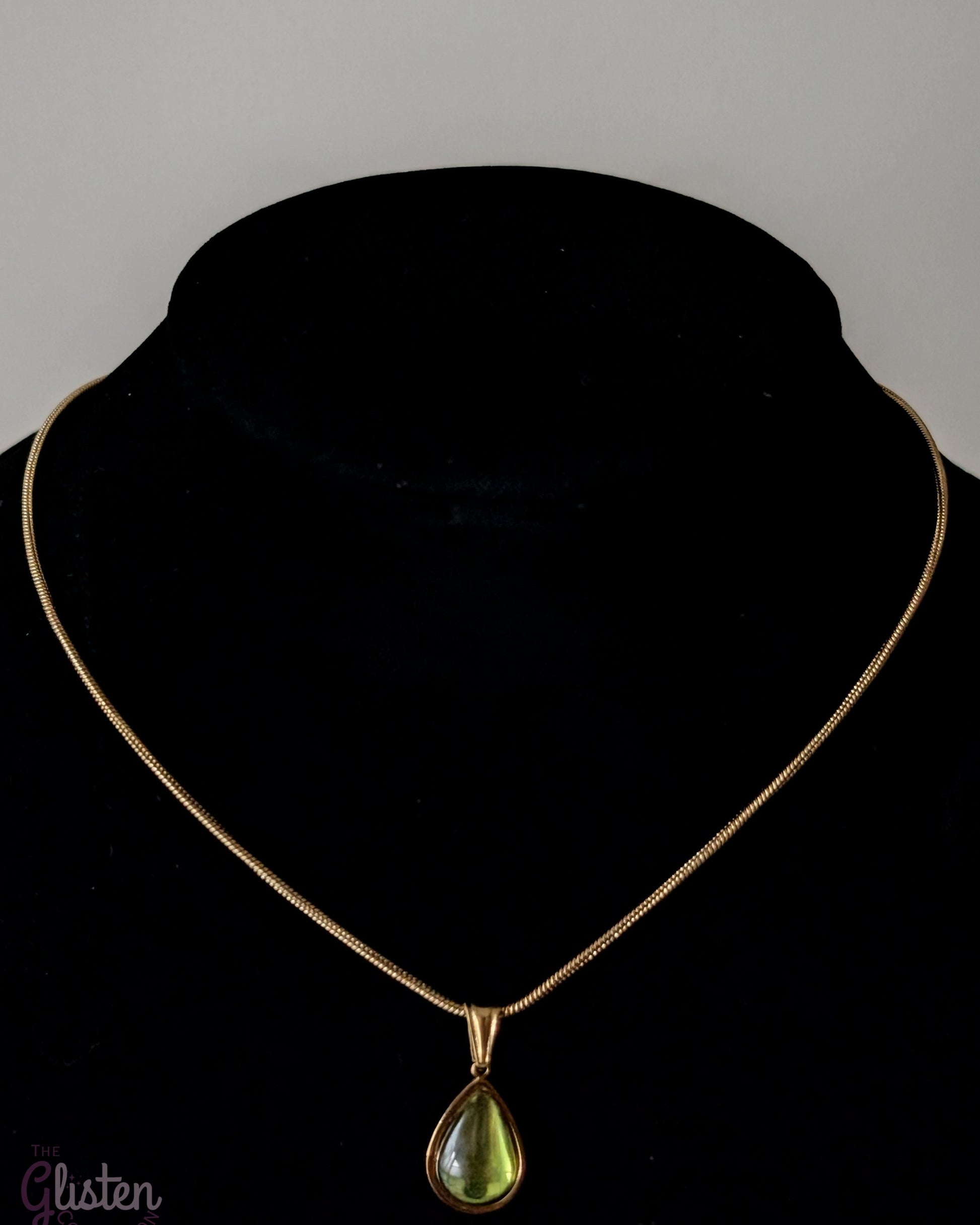 Elegant green glass droplet pendant necklace with stainless steel and 18K gold plating, offering a minimalist and refined look.