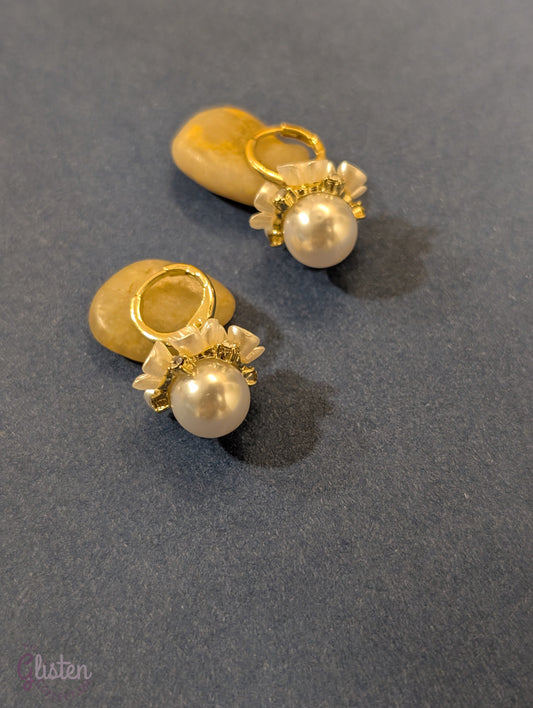 Flower-shaped drop earrings with rhinestone detailing and pearl dangle, perfect for elegant styling and special occasions.