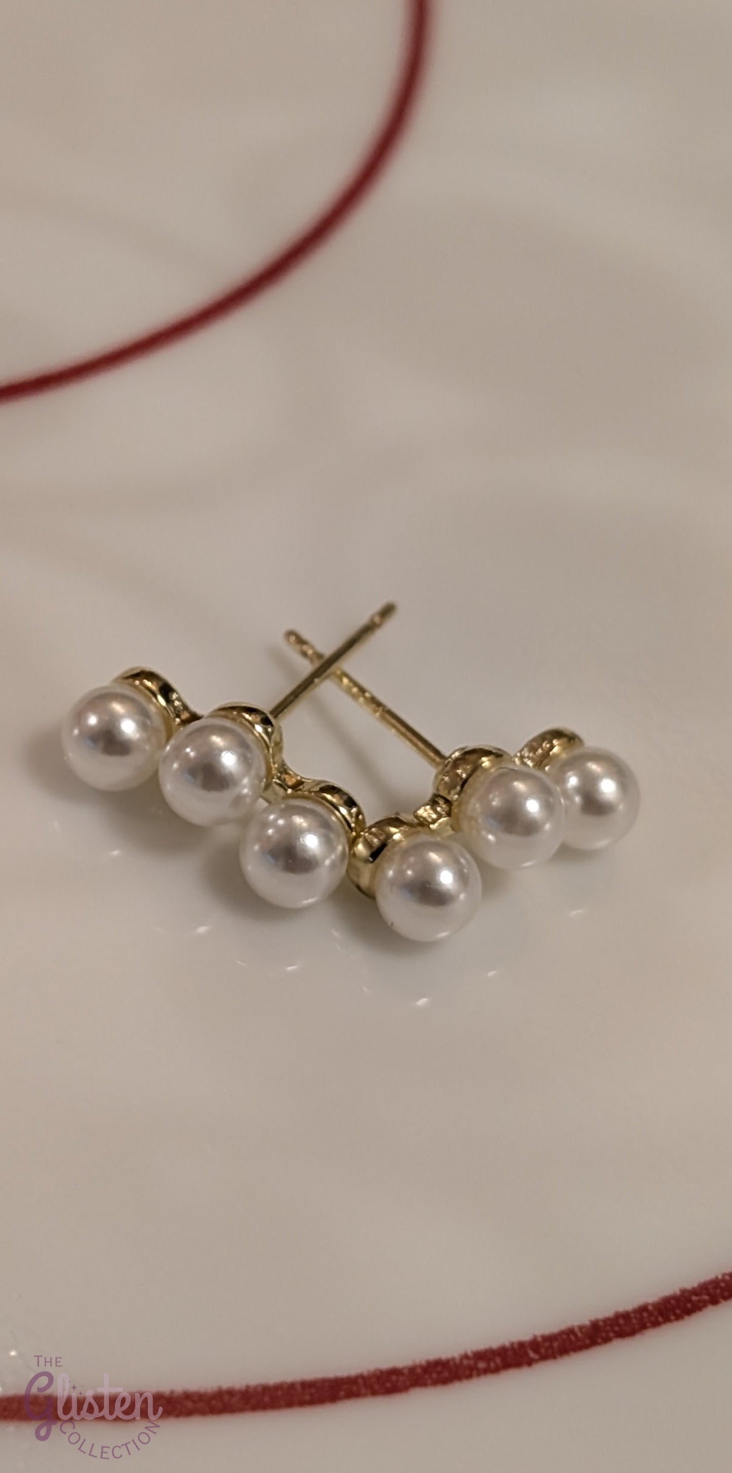Round gold-plated pearl stud earrings with a minimalist design for everyday and office wear.