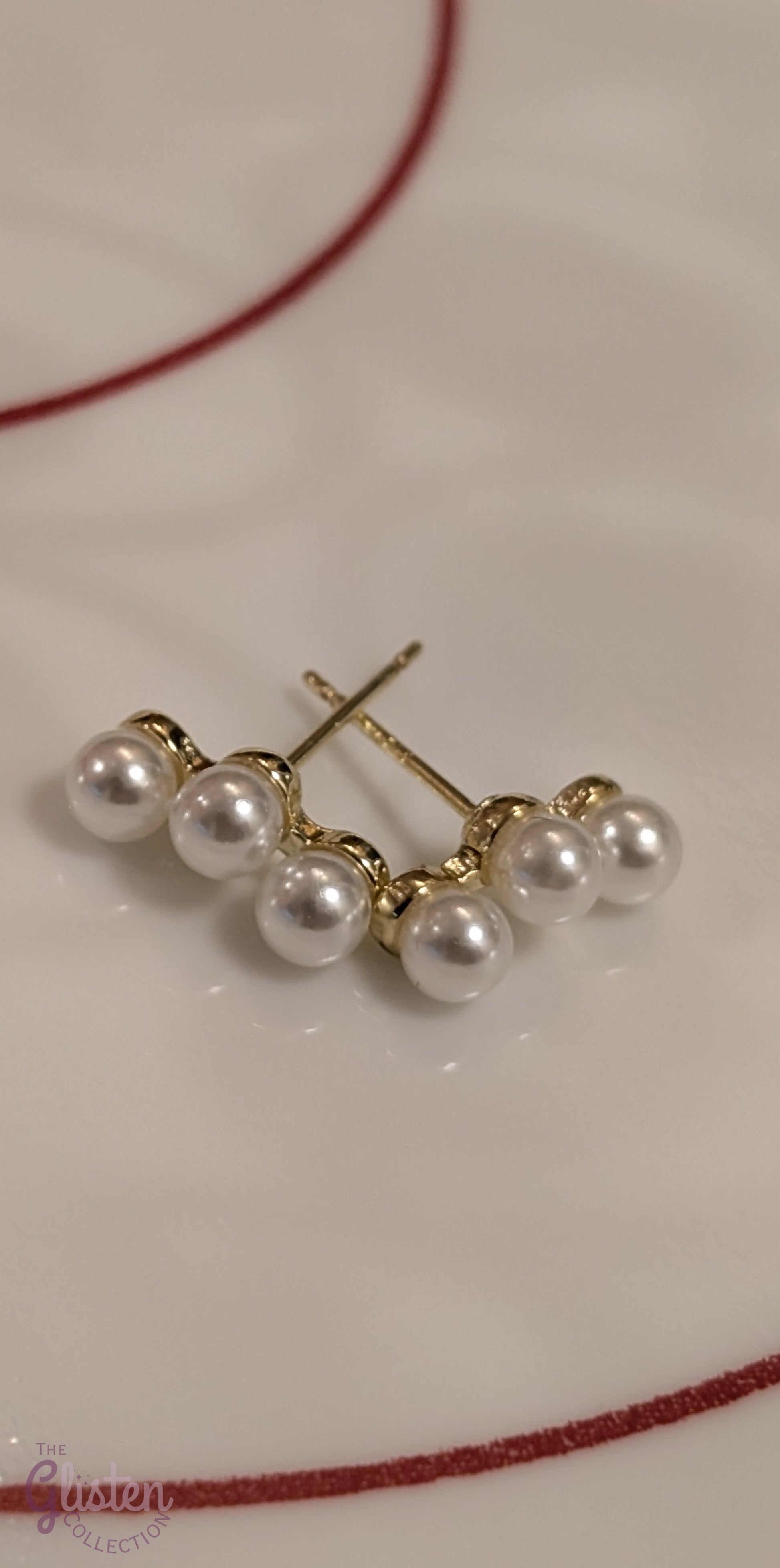 Round gold-plated pearl stud earrings with a minimalist design for everyday and office wear.