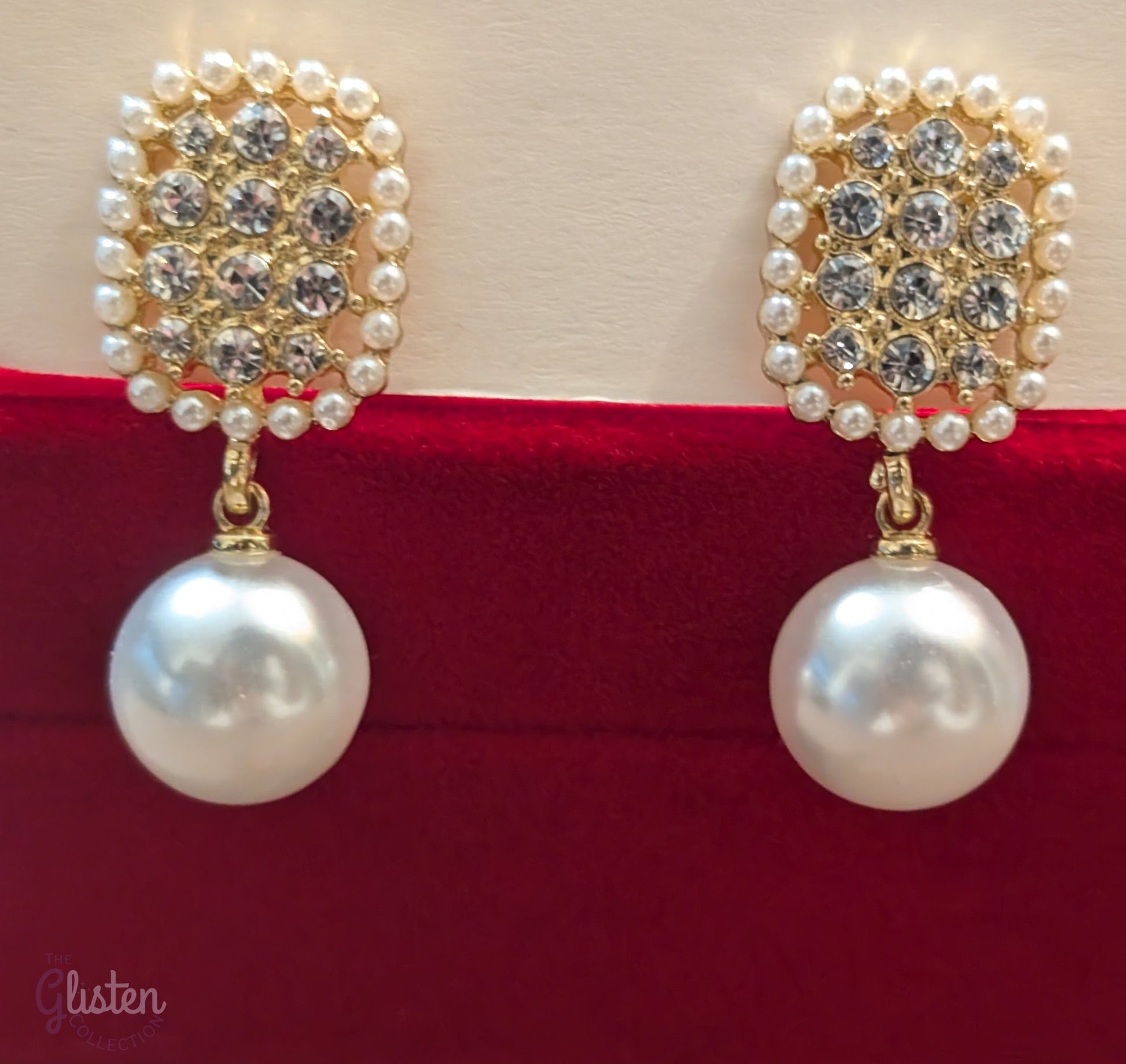 Geometric pearl drop earrings with oval-shaped tops, imitation pearls, and artificial crystals.