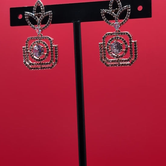 Rose gold-plated earrings with American diamond stones in leaf and teardrop design — perfect blend of traditional and contemporary elegance.
