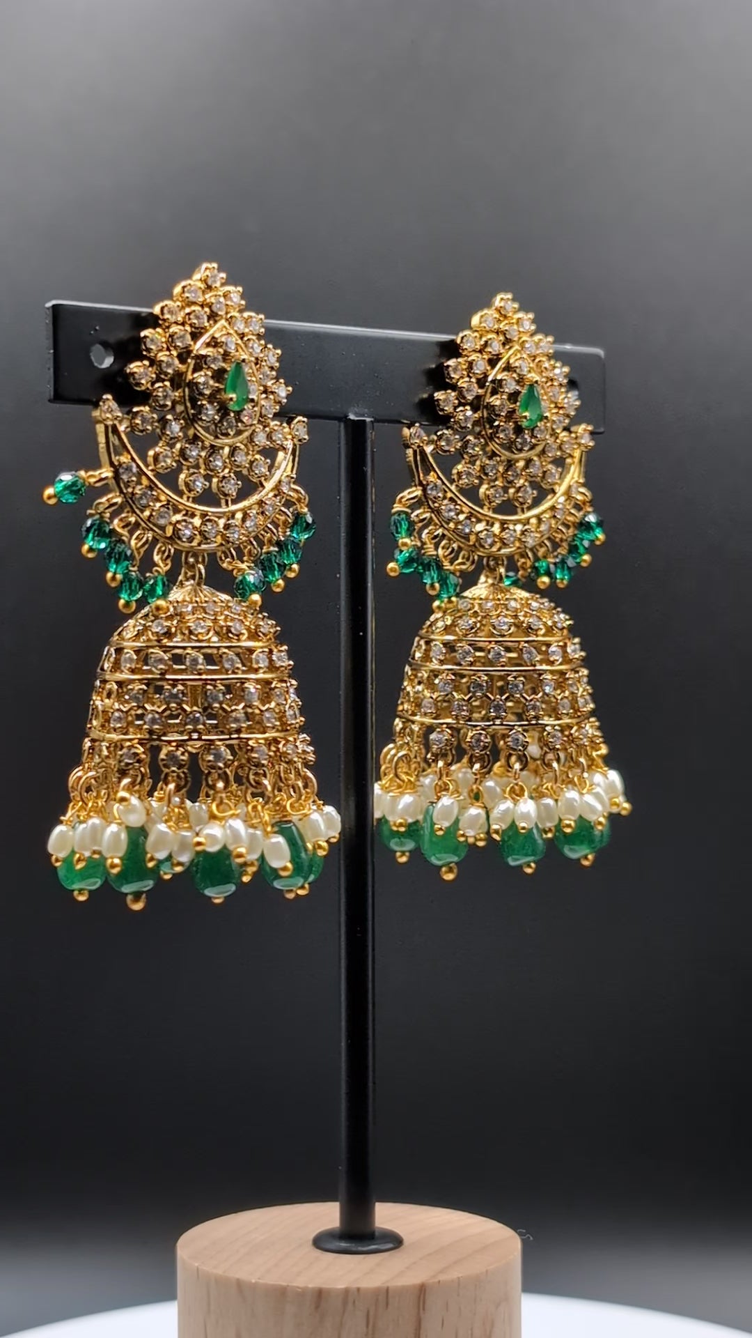 Moonlit Jhumka Charms earrings with crescent shape, green stones, and sparkling CZ details — perfect for enhancing special occasion looks.