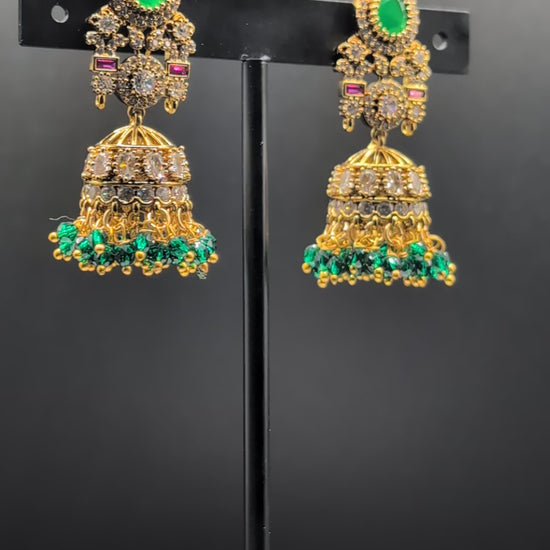 Emerald Flow Jhumkas with green stones, delicate accents, and green bead dangles — perfect for simple yet festive looks at parties and special occasions.