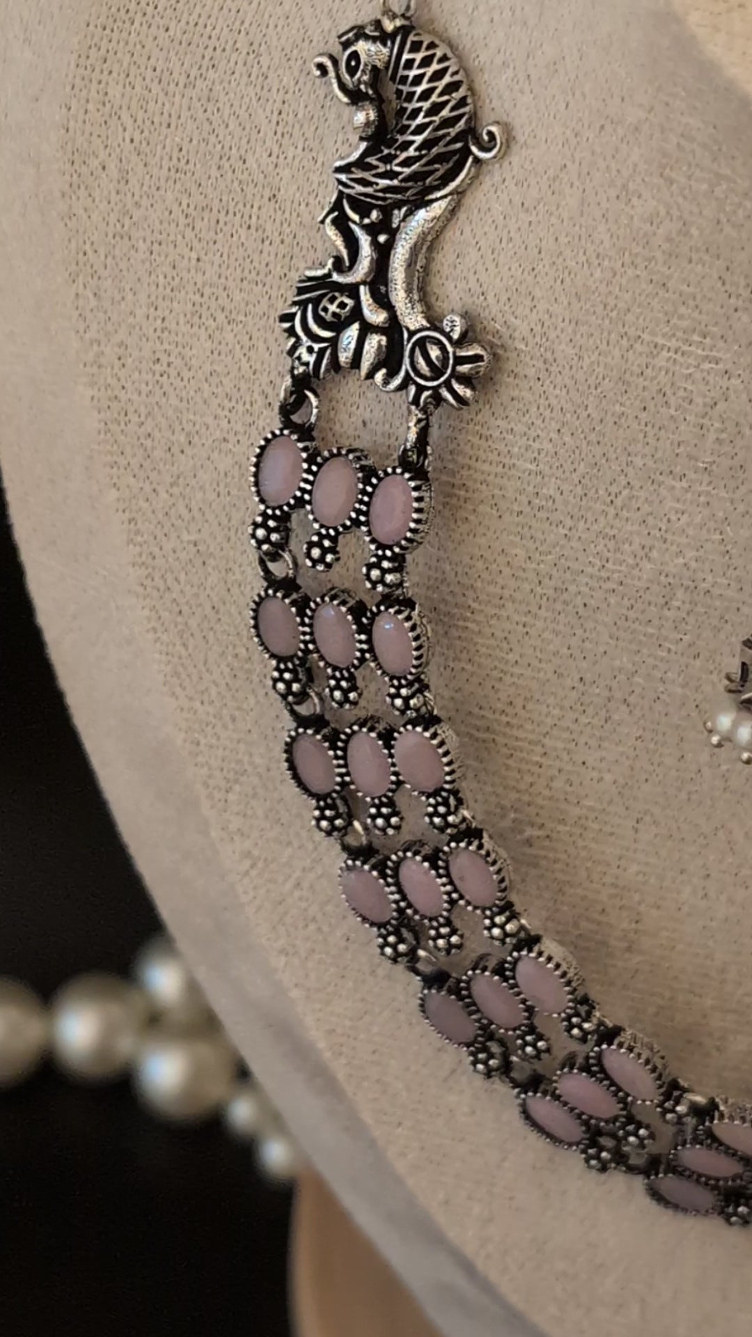 Three-layered oxidized German silver necklace with peacock motifs and matching pearl jhumkas — ideal for weddings, traditional functions, and festive occasions.