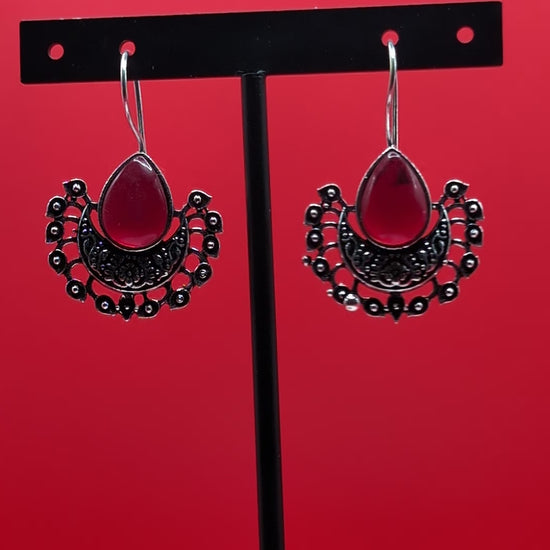 Boho-style oxidized earrings with a single ocean blue teardrop stone from The Glisten Collection.