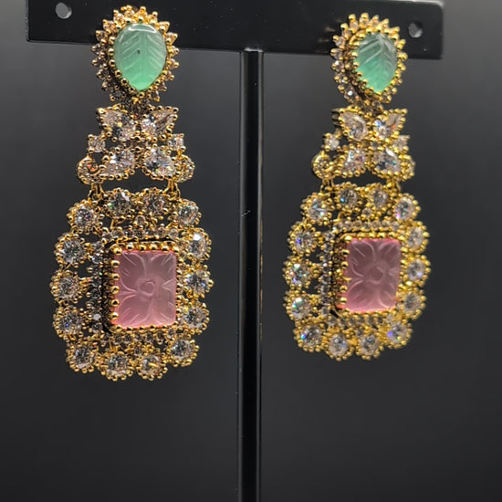 Rose Dew Drops earrings with pink square base, green tear-drop top, and Moissanite stones — ideal for modern or traditional occasions.