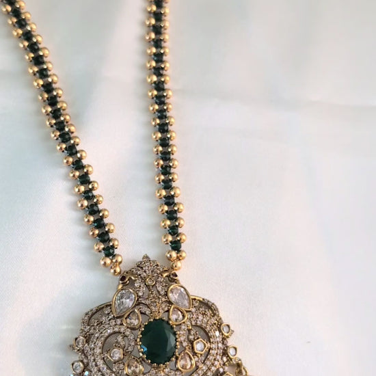 Green color chain necklace with ornate CZ pendant and dangling green stones — elegant festive jewellery for all ages, perfect for weddings and celebrations.
