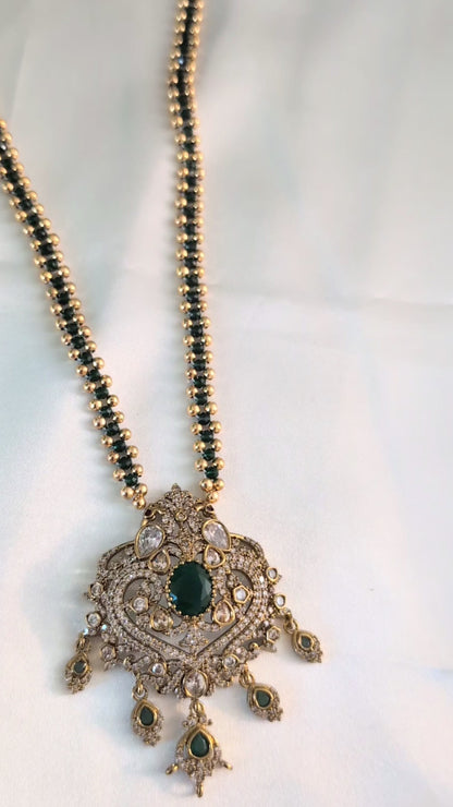 Green color chain necklace with ornate CZ pendant and dangling green stones — elegant festive jewellery for all ages, perfect for weddings and celebrations.